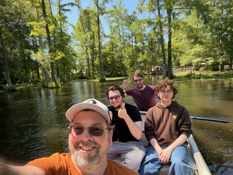 Korey Mercier and his three sons in a rowboat